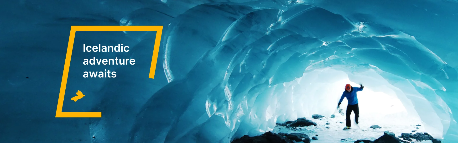 Explorer standing inside a blue ice cave in Iceland