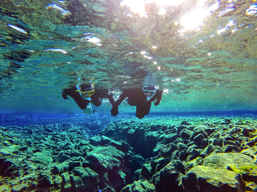 rock formations visible in the crystal clear glacial water