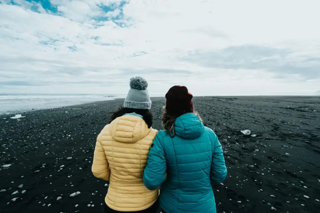 Two people in a jacked and a hat in Icelandic nature